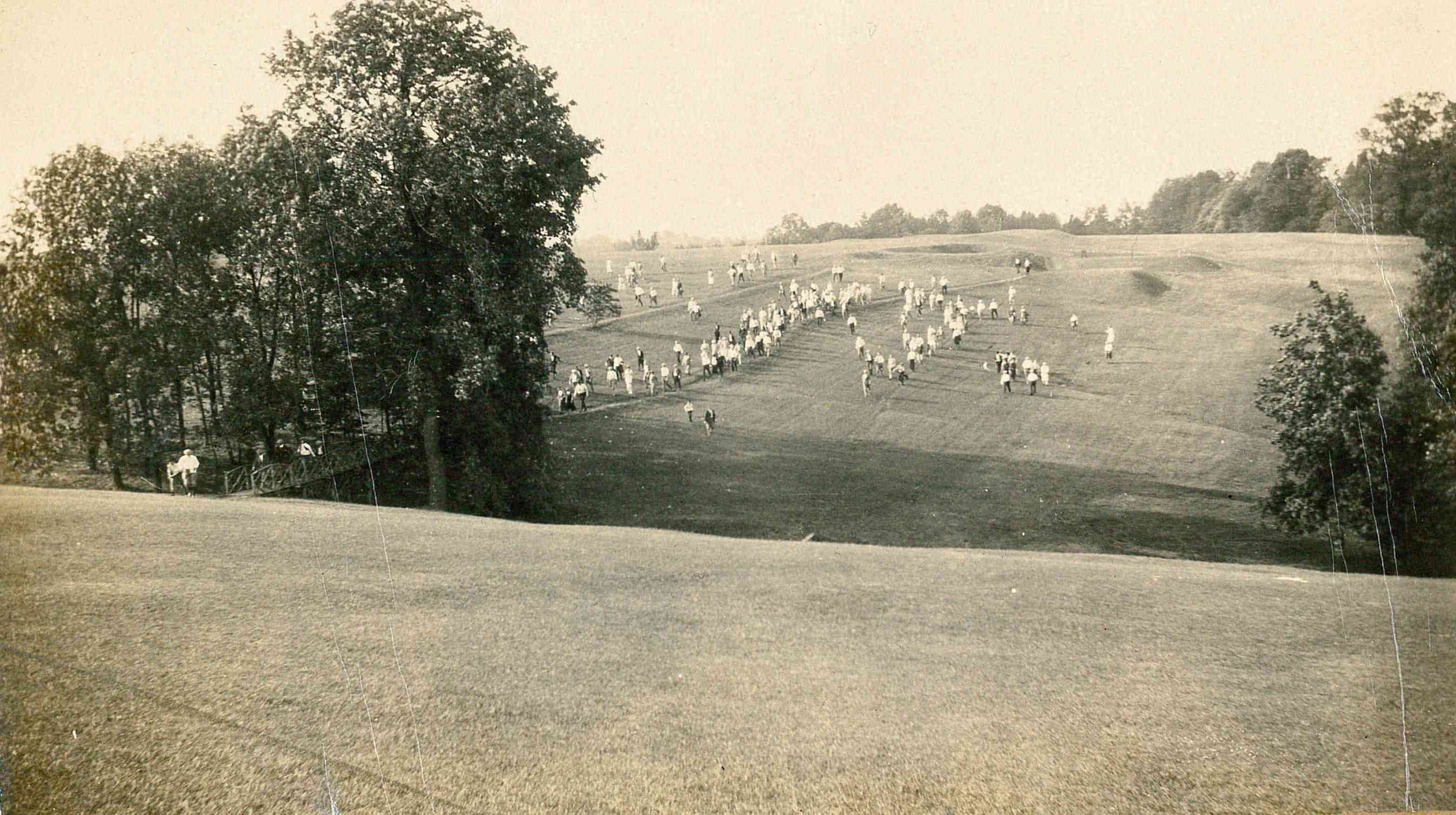 a group of people walking on a field