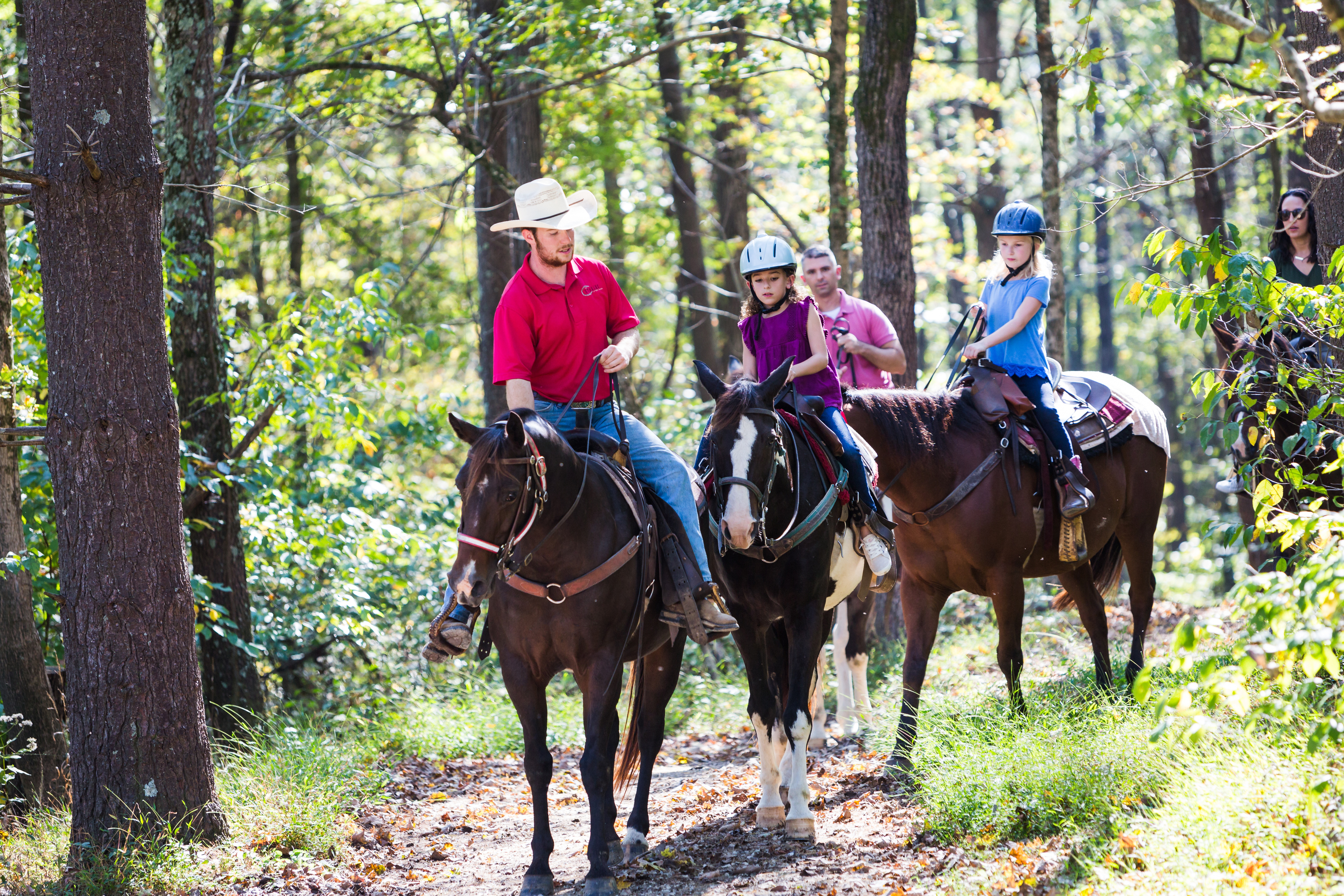 a group of people riding horses