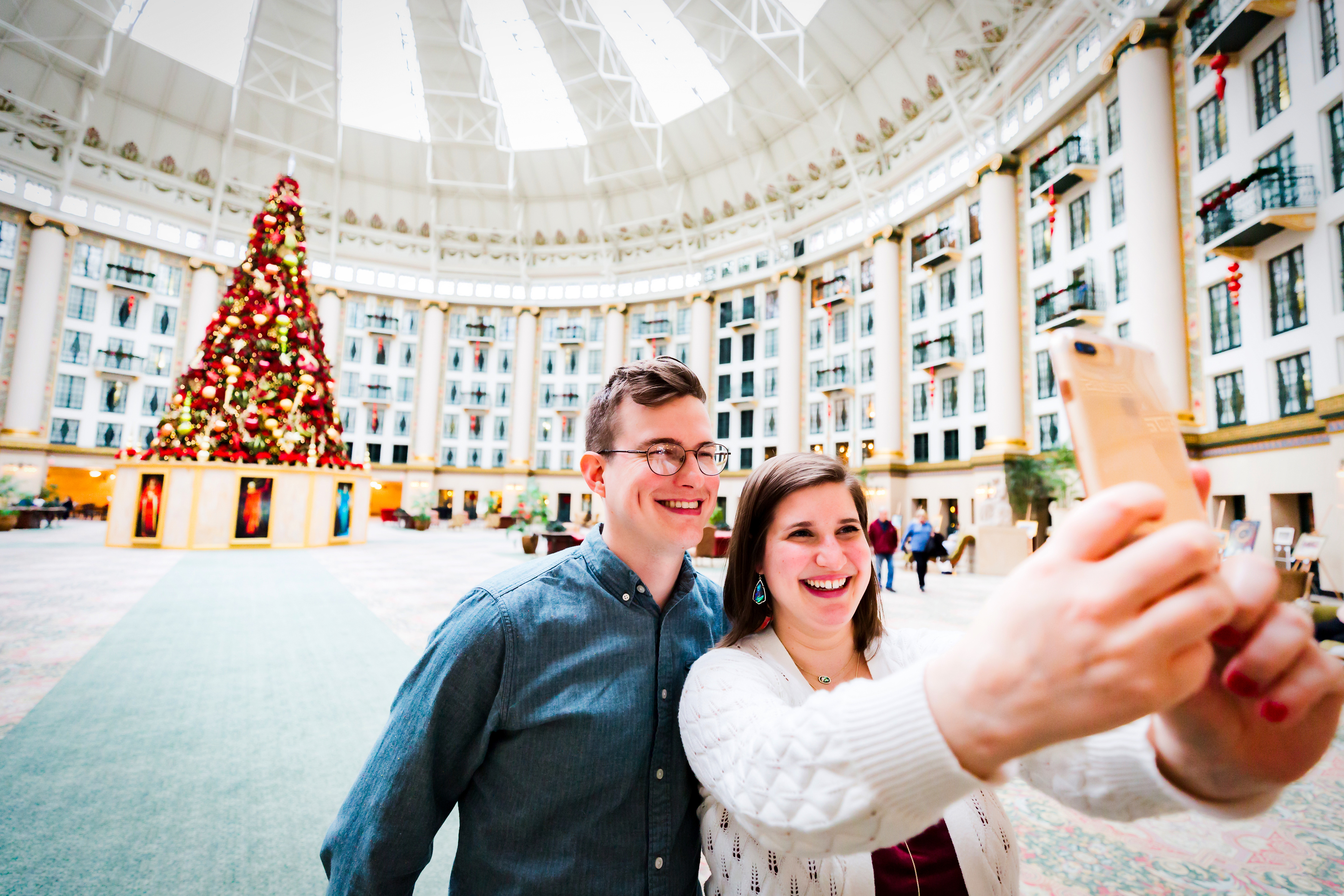 a man and woman taking a selfie in a large building