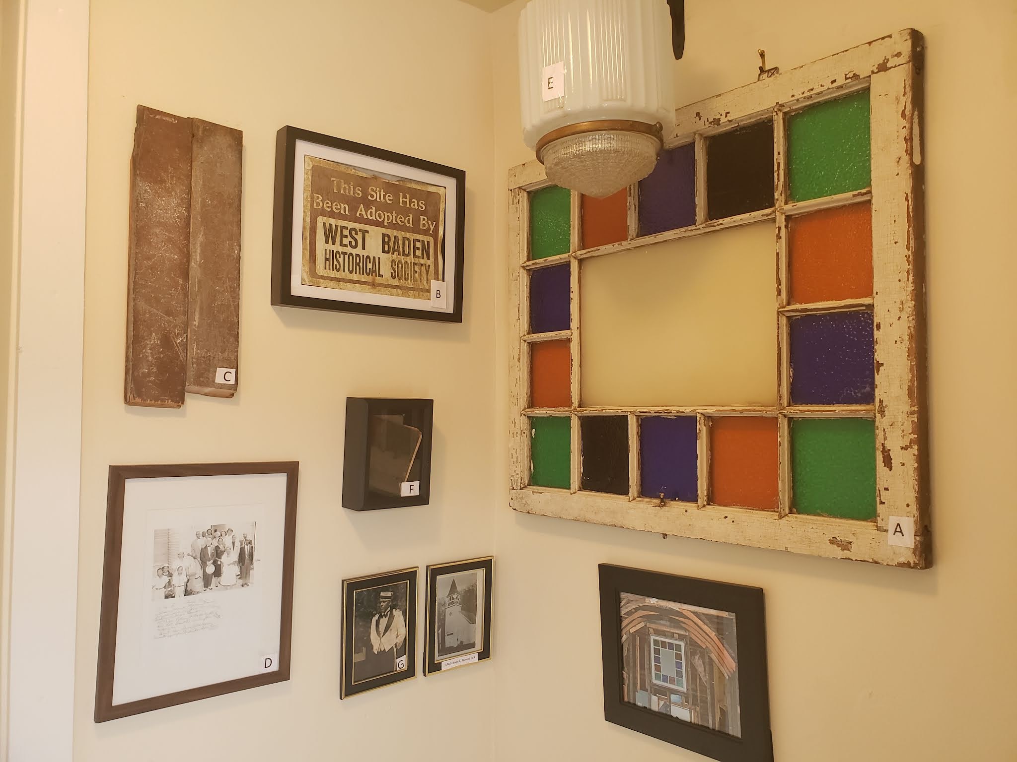 a wall with pictures and frames