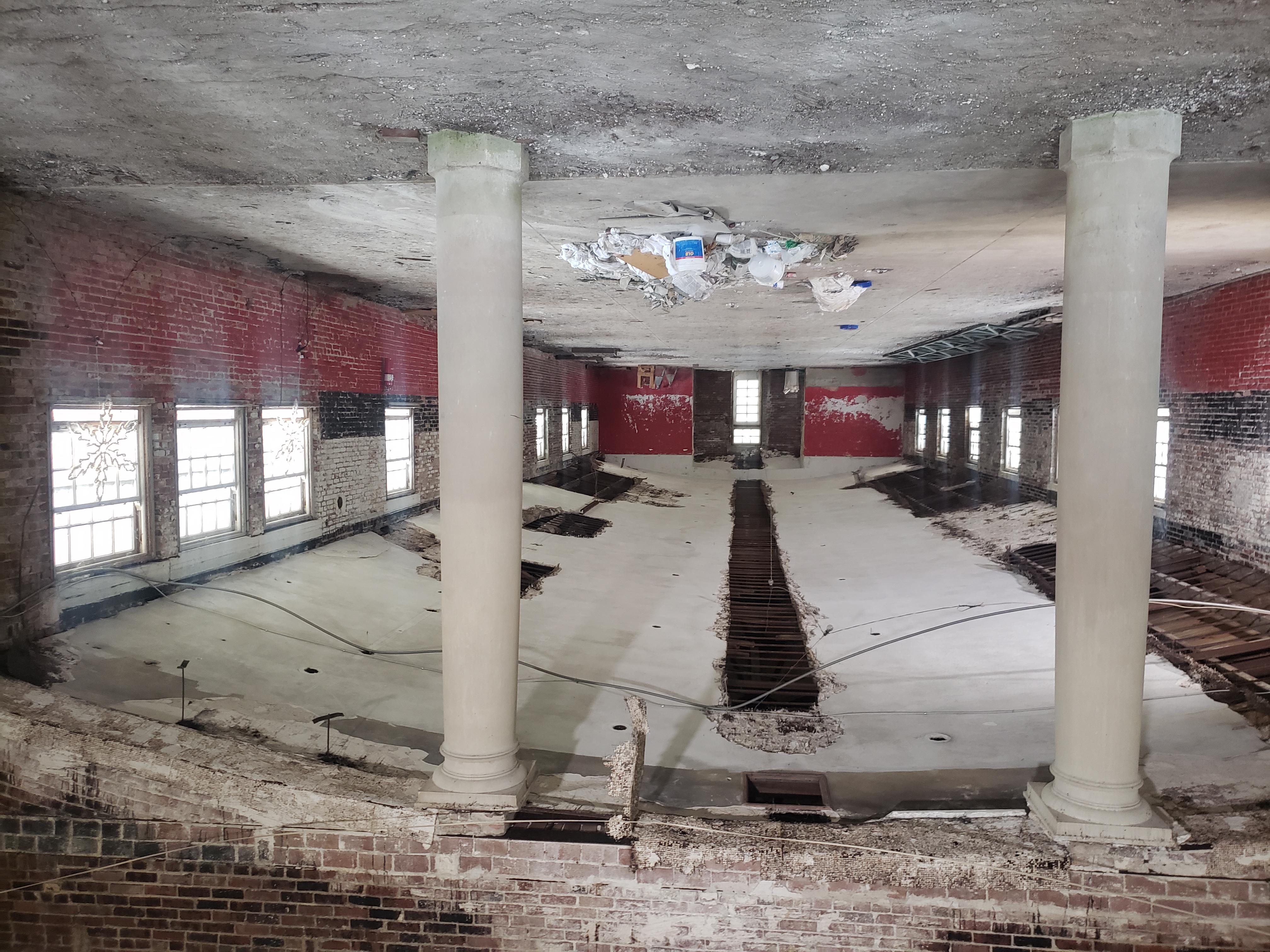 a large room with columns and debris