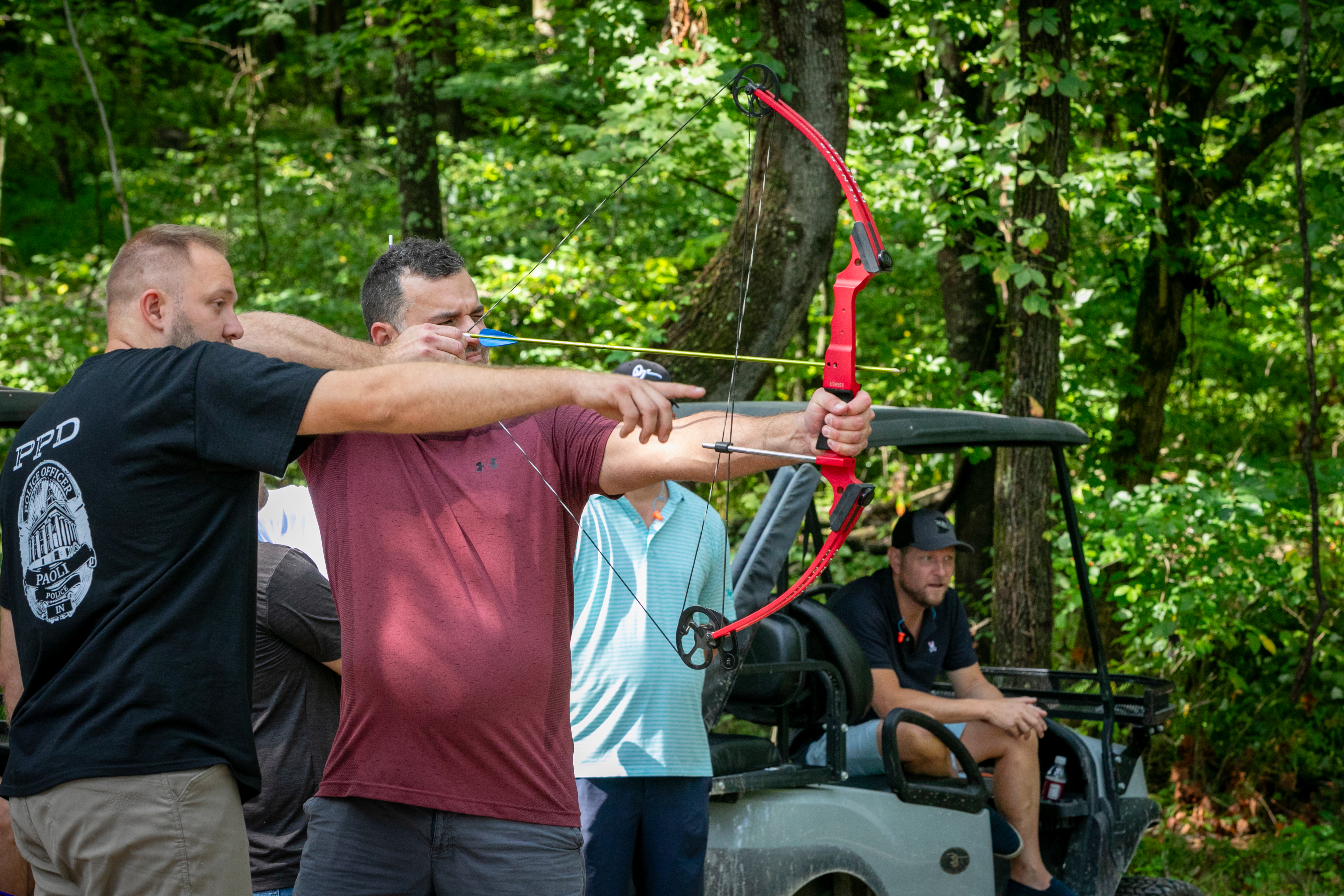 a group of men shooting a bow and arrow