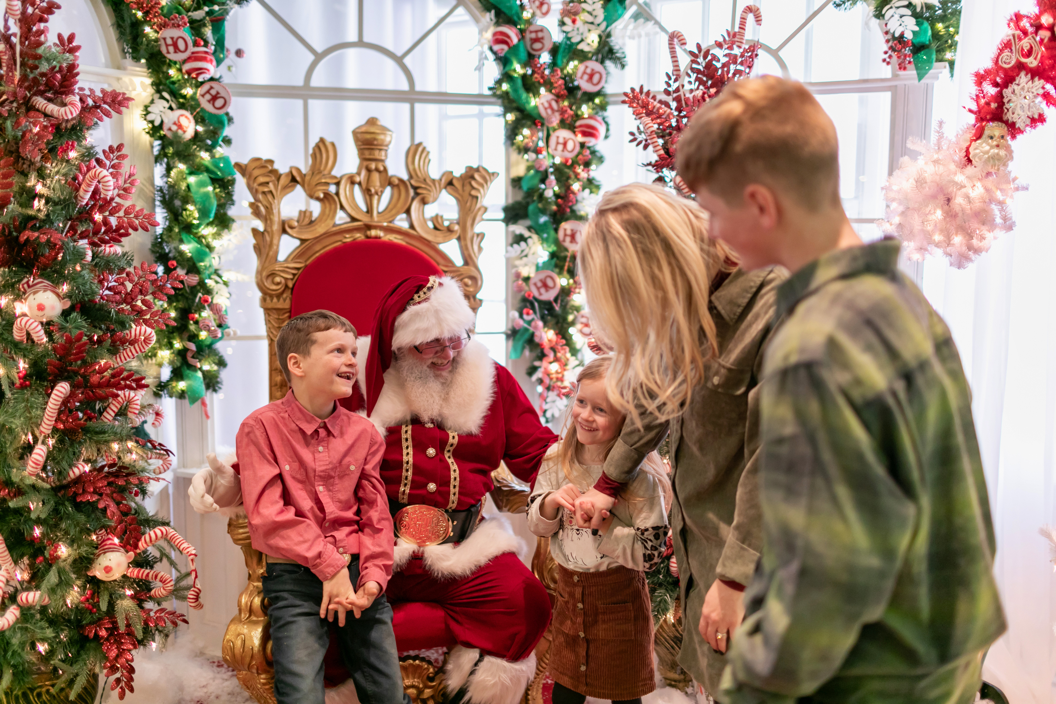 a group of people standing around a santa claus