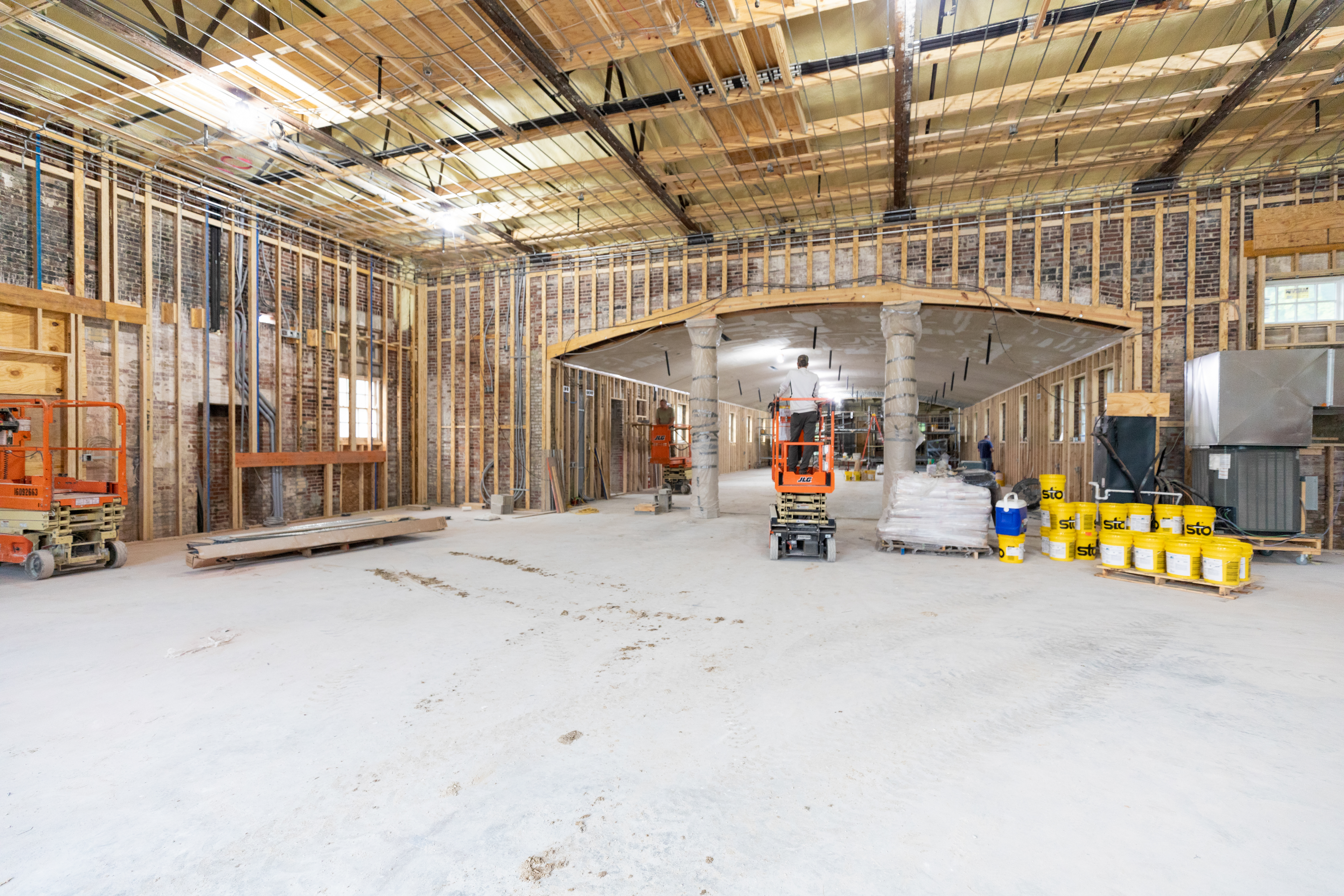 a construction site with a few workers