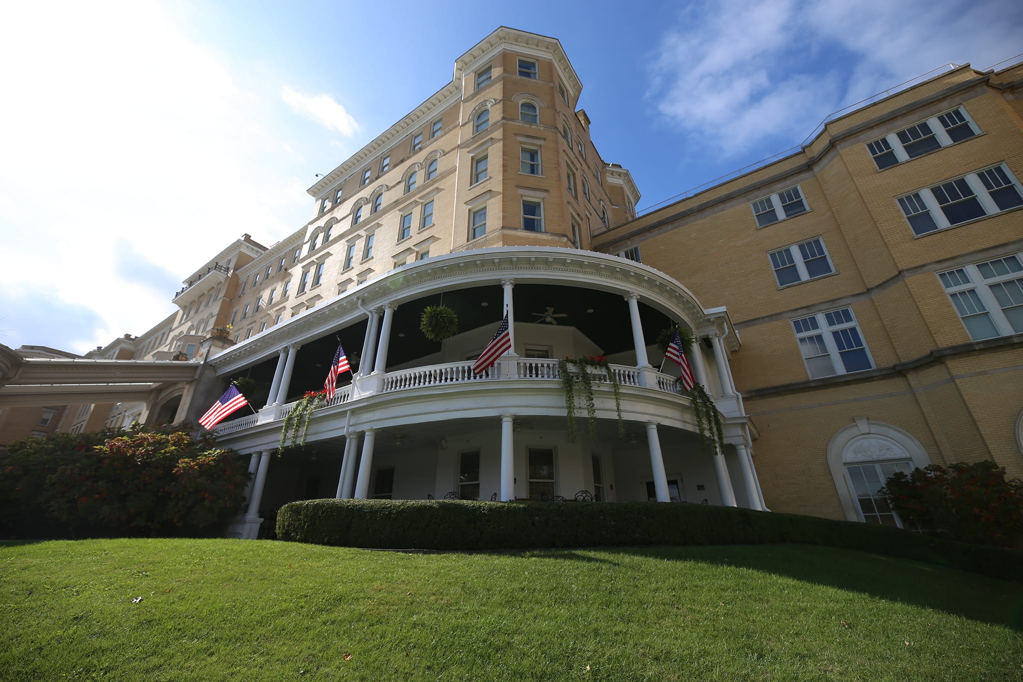 a building with a lawn and flags