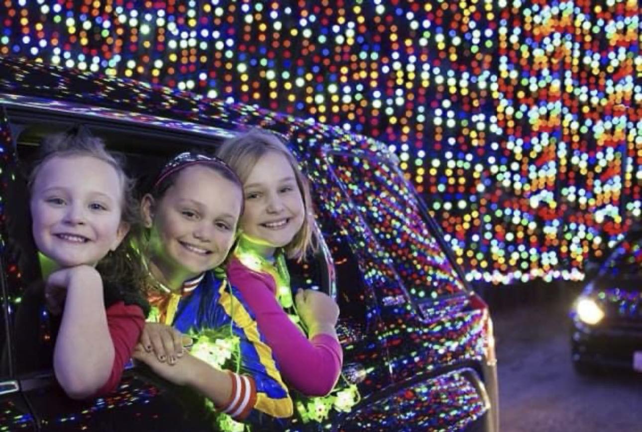 a group of girls in a car with lights