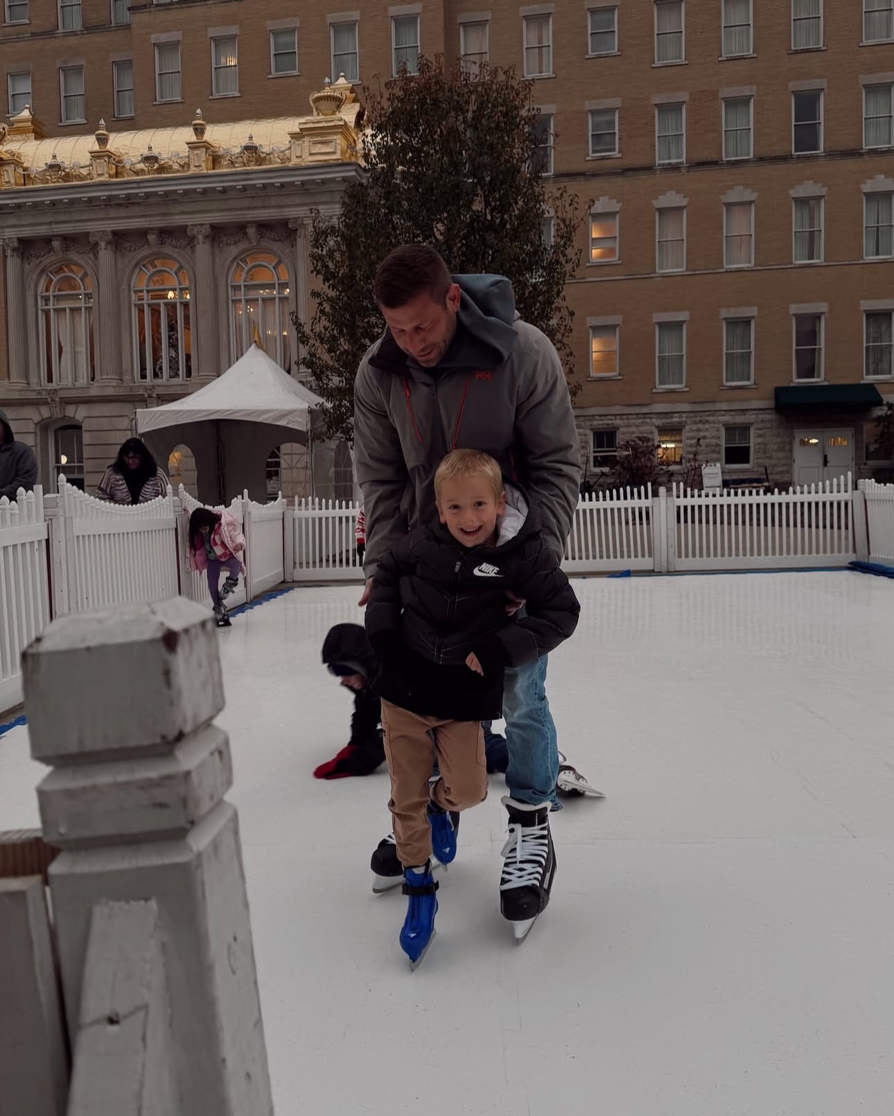 a man holding a child on ice