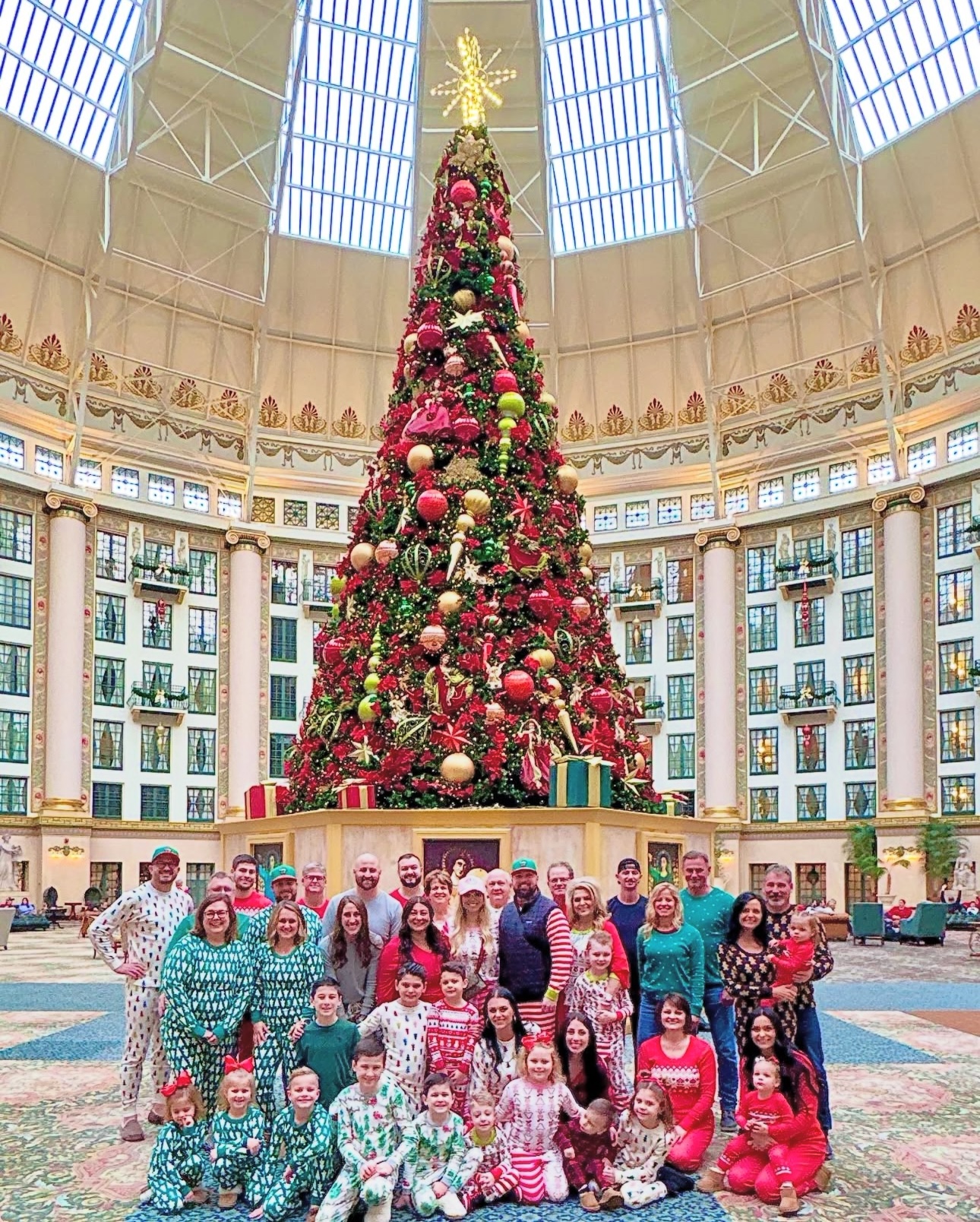 a group of people posing for a photo in a large building