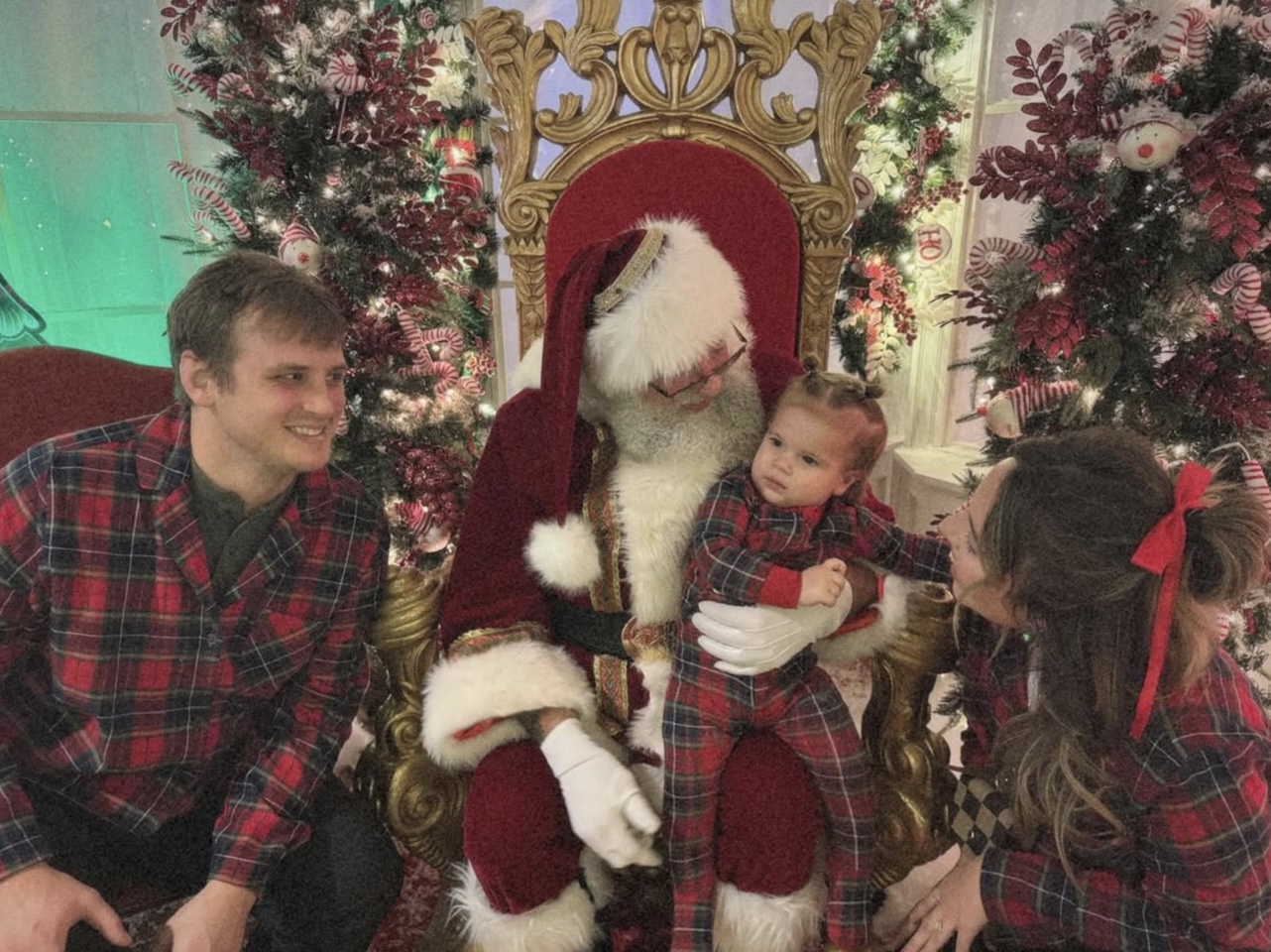 a group of people sitting in a chair with a baby