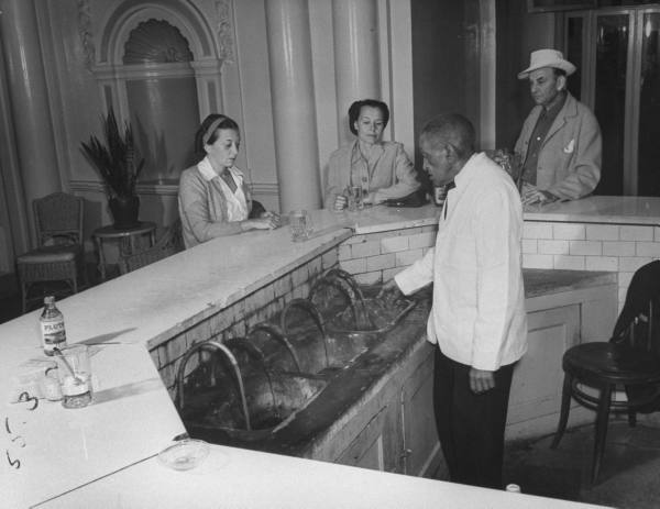 a group of people standing around a bar