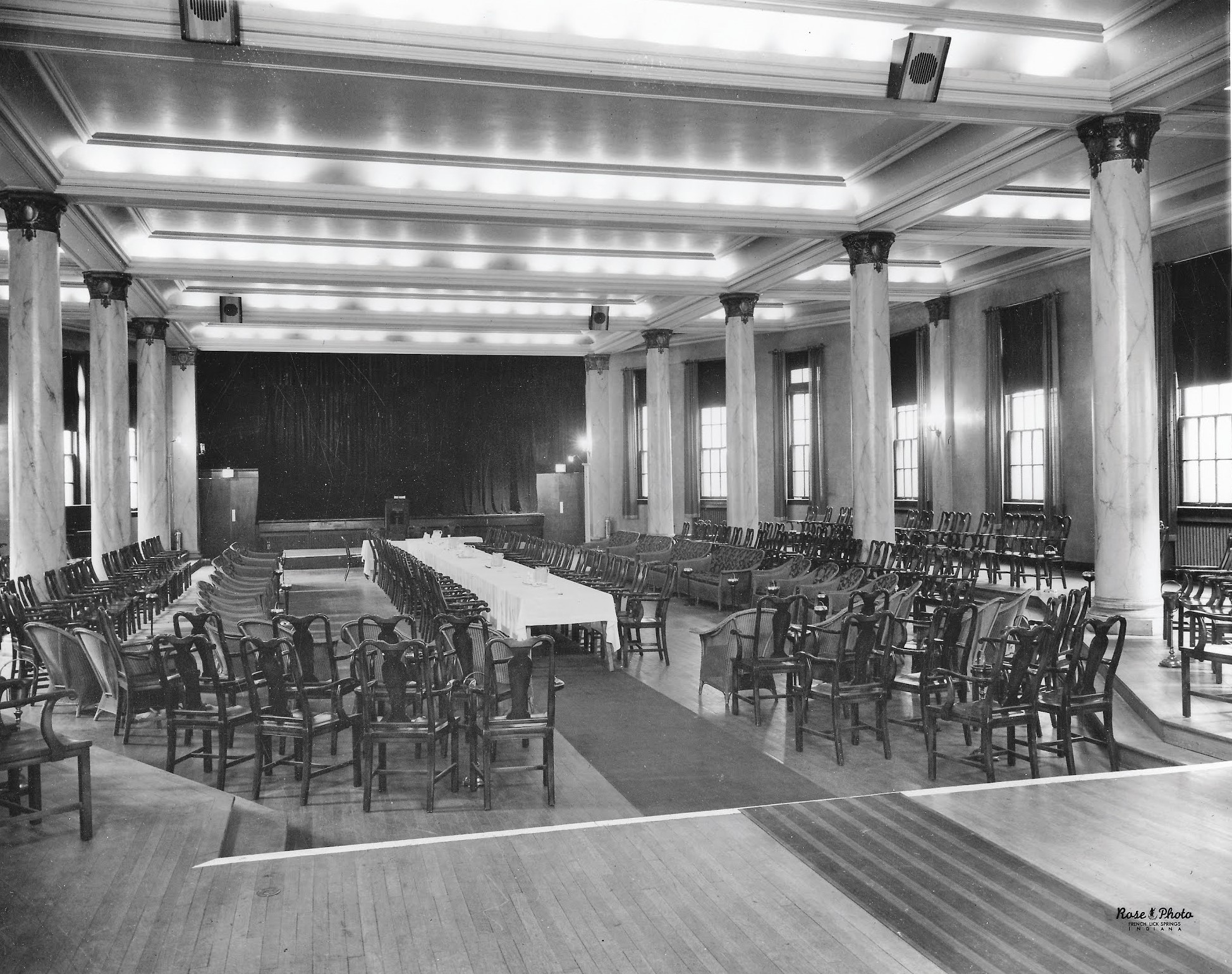 a room with many chairs and tables