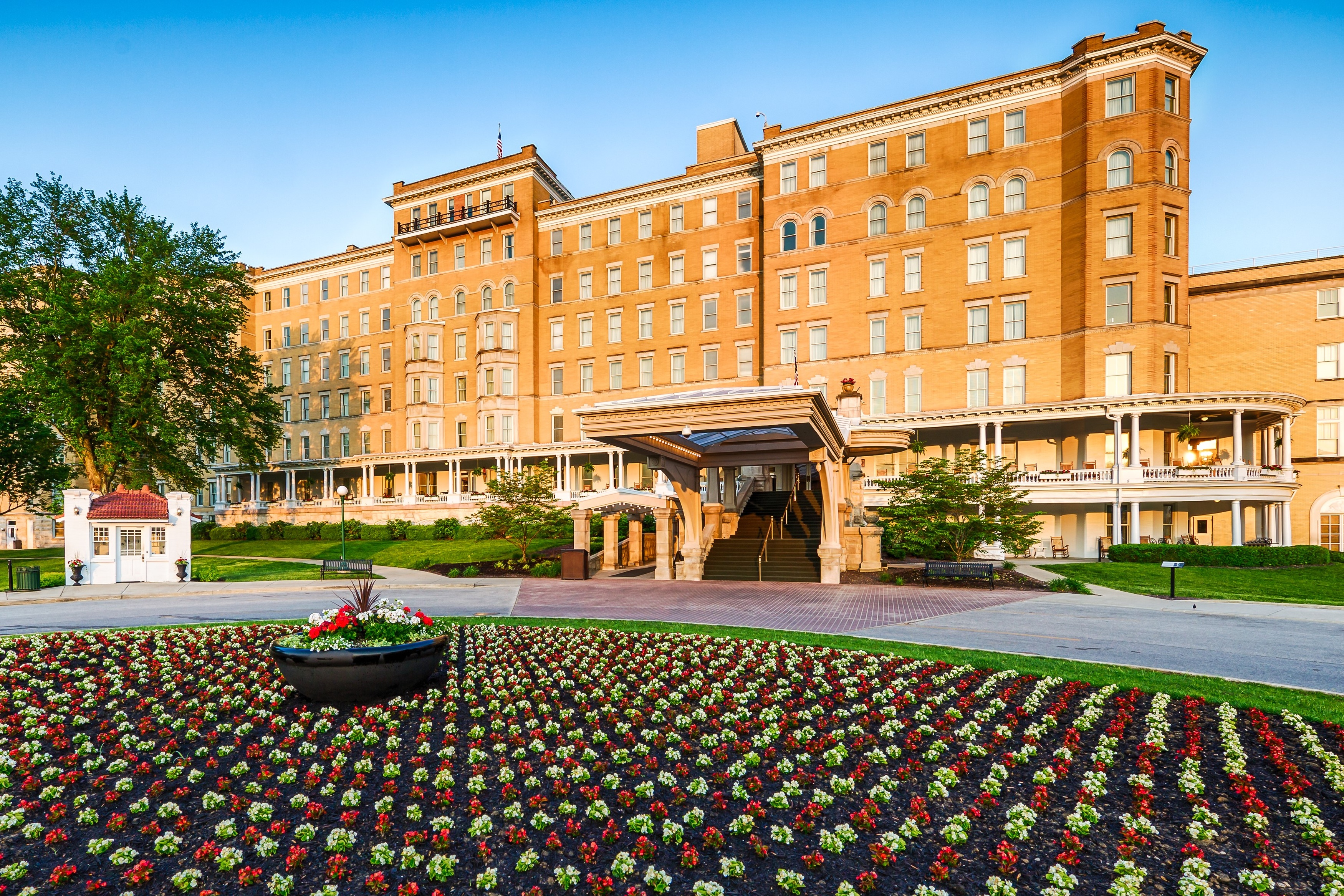 a large building with a flower bed in front of it