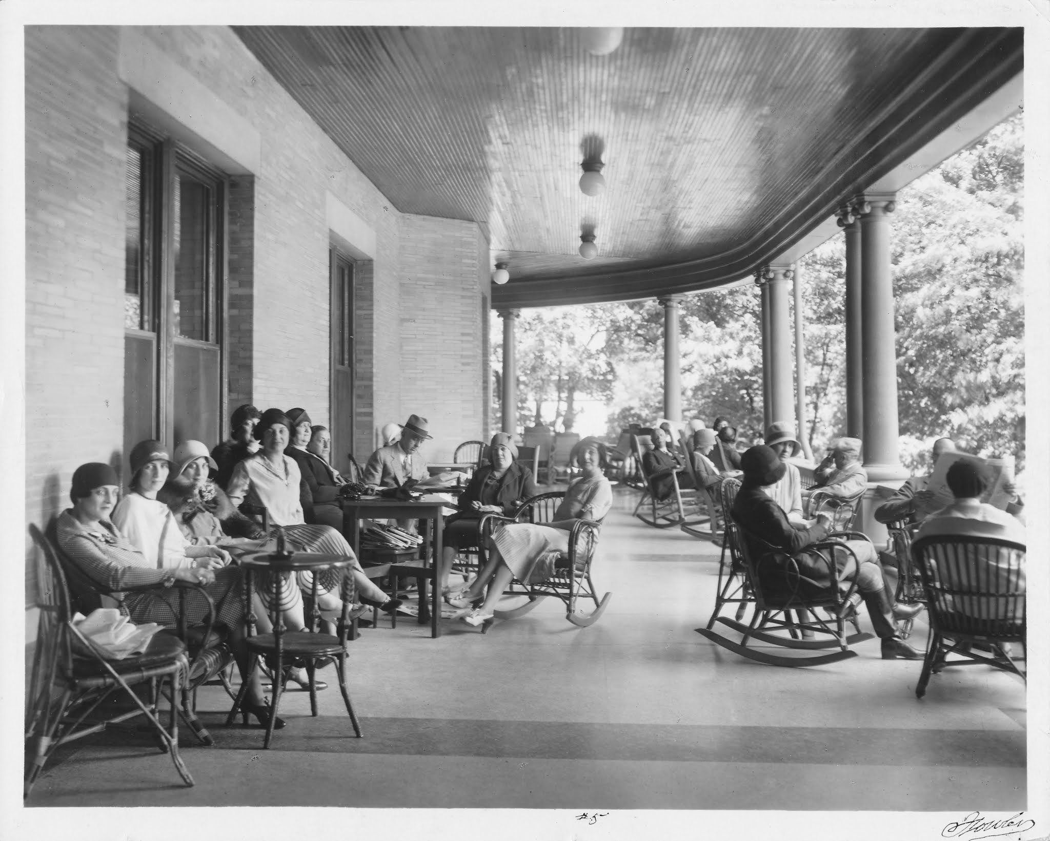 Guests rocking on the veranda at French Lick Springs Hotel