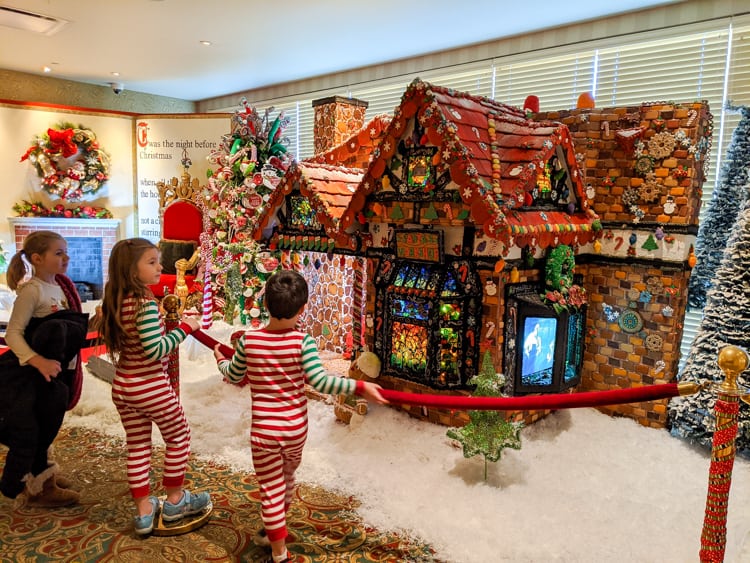 a boy and girl in striped pajamas playing with a red rope