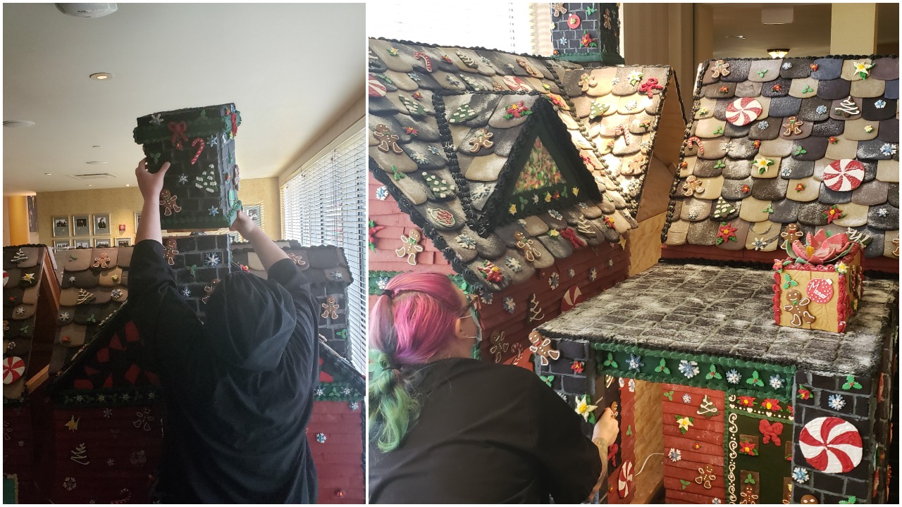 a woman building a gingerbread house