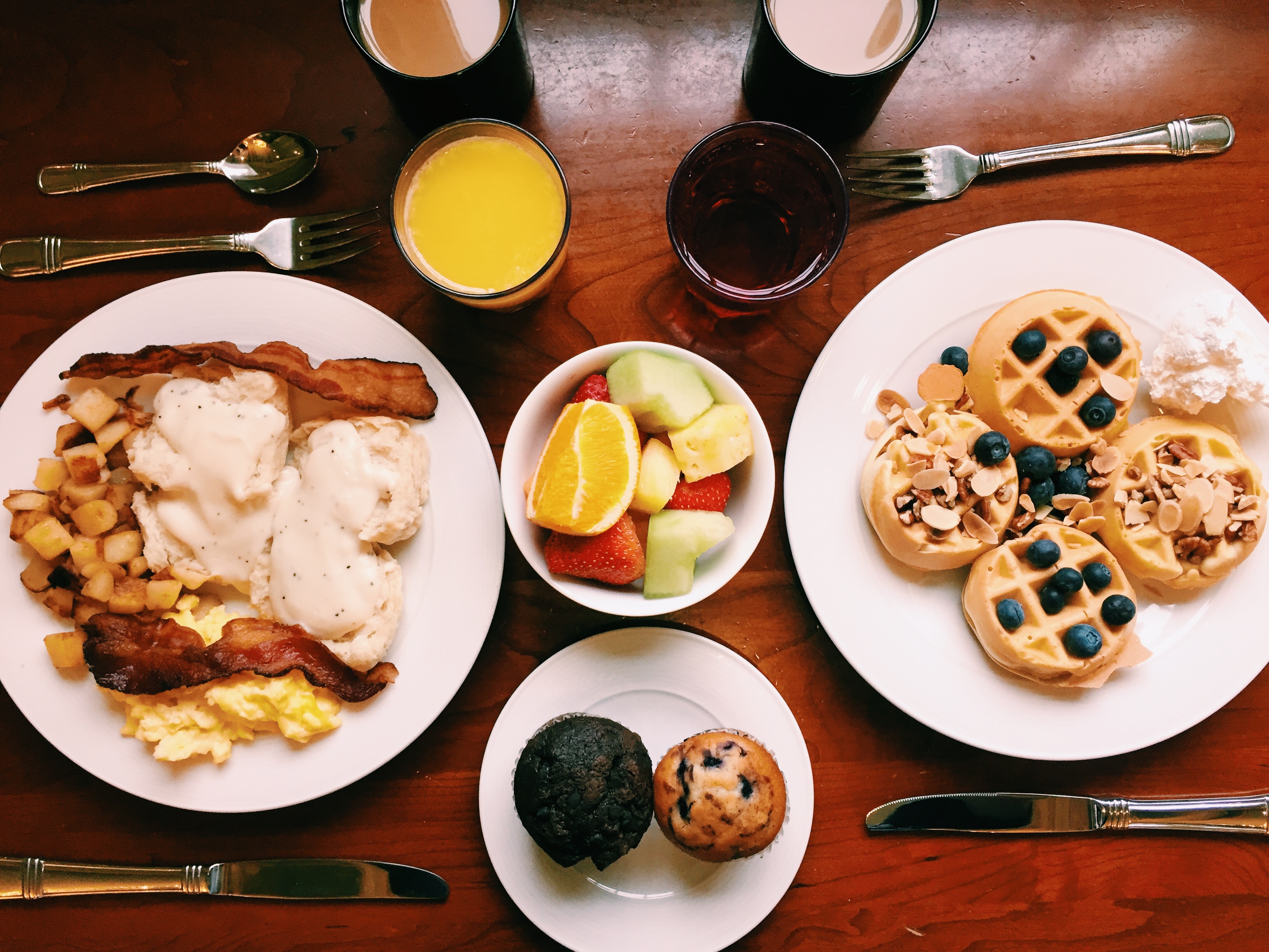 a table with plates of food and drinks