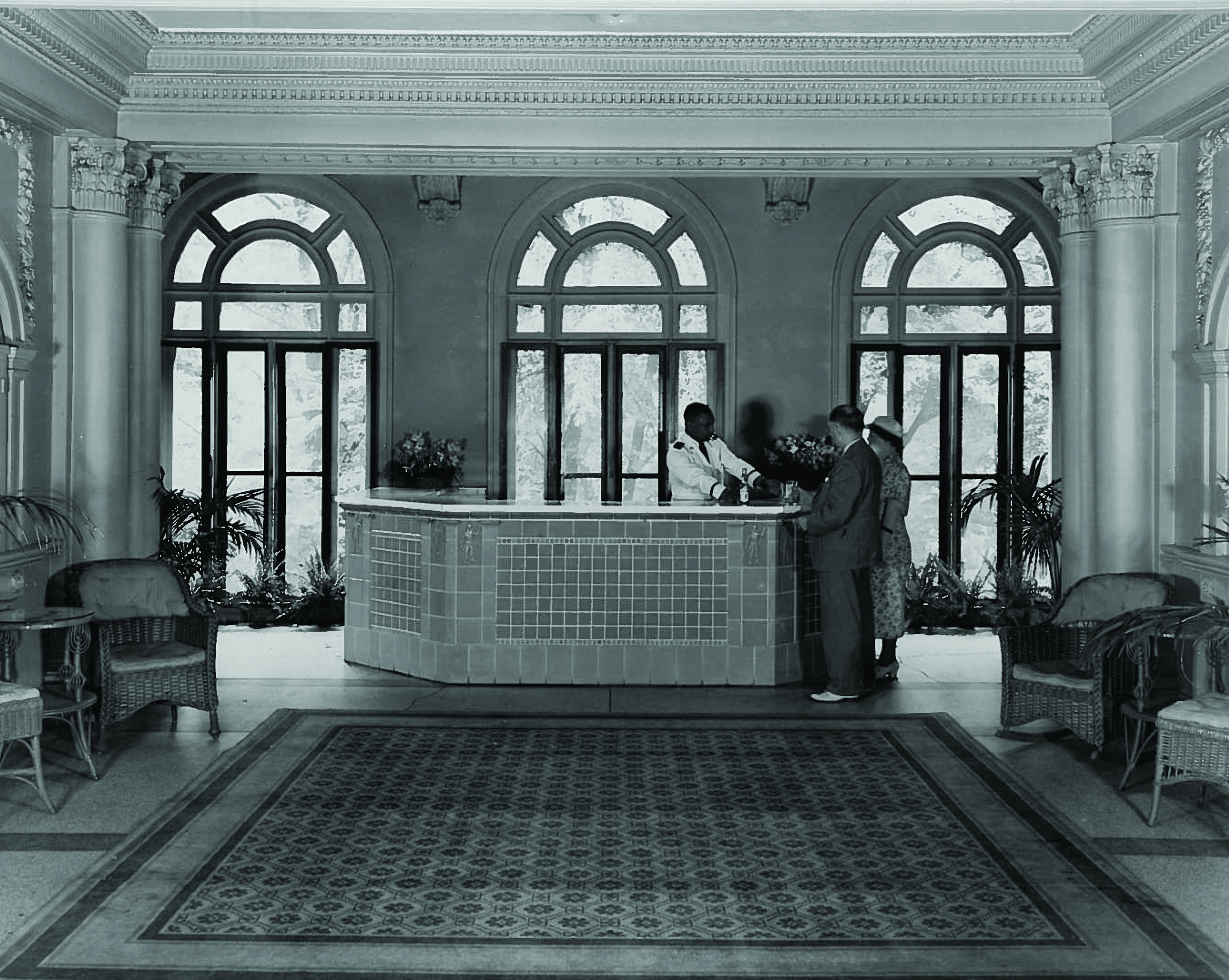 a group of people standing at a reception desk