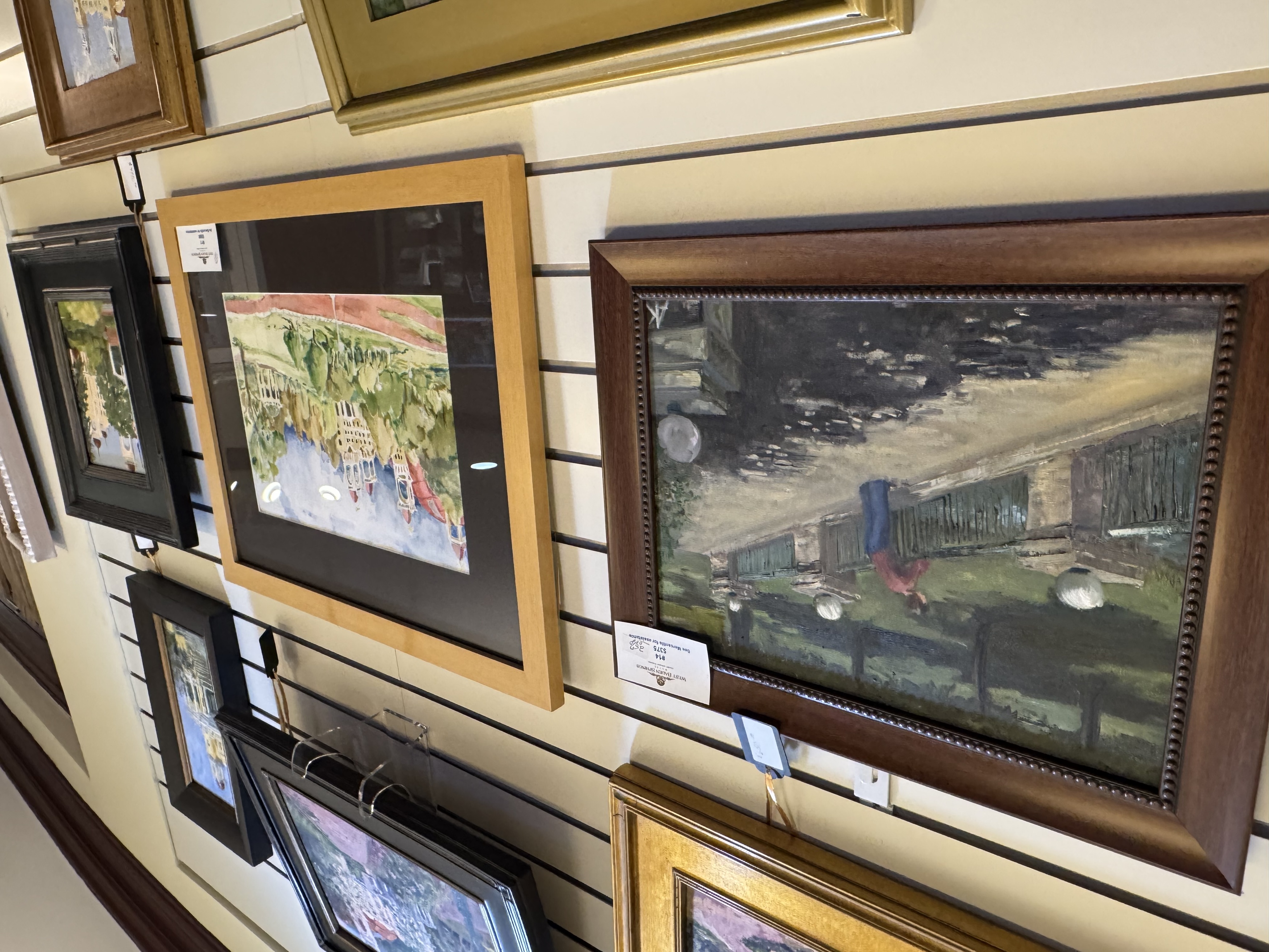 a group of framed pictures on a wall