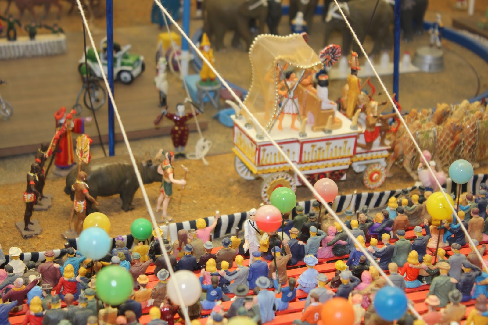 a toy circus with many people and balloons