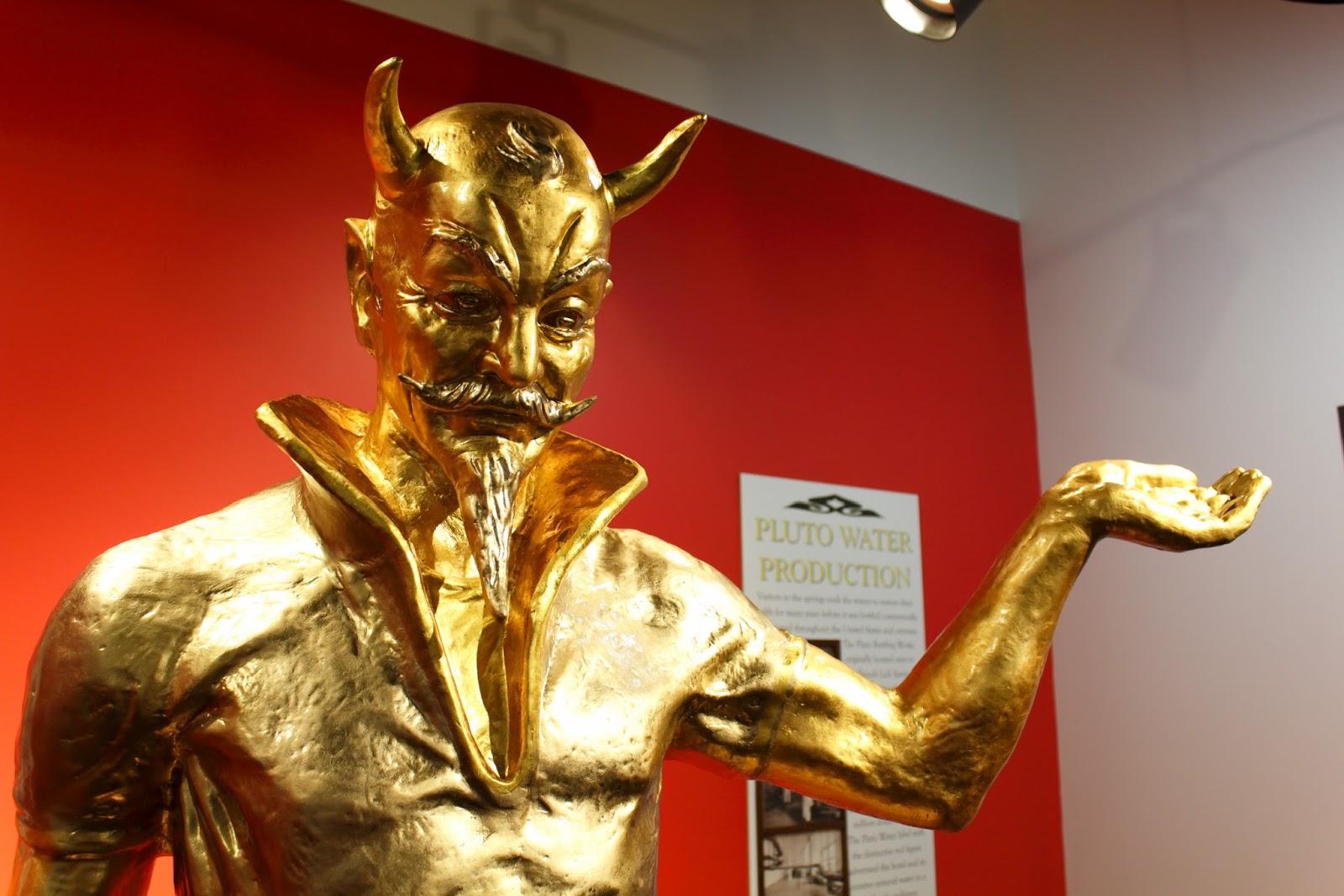 a gold statue of a devil