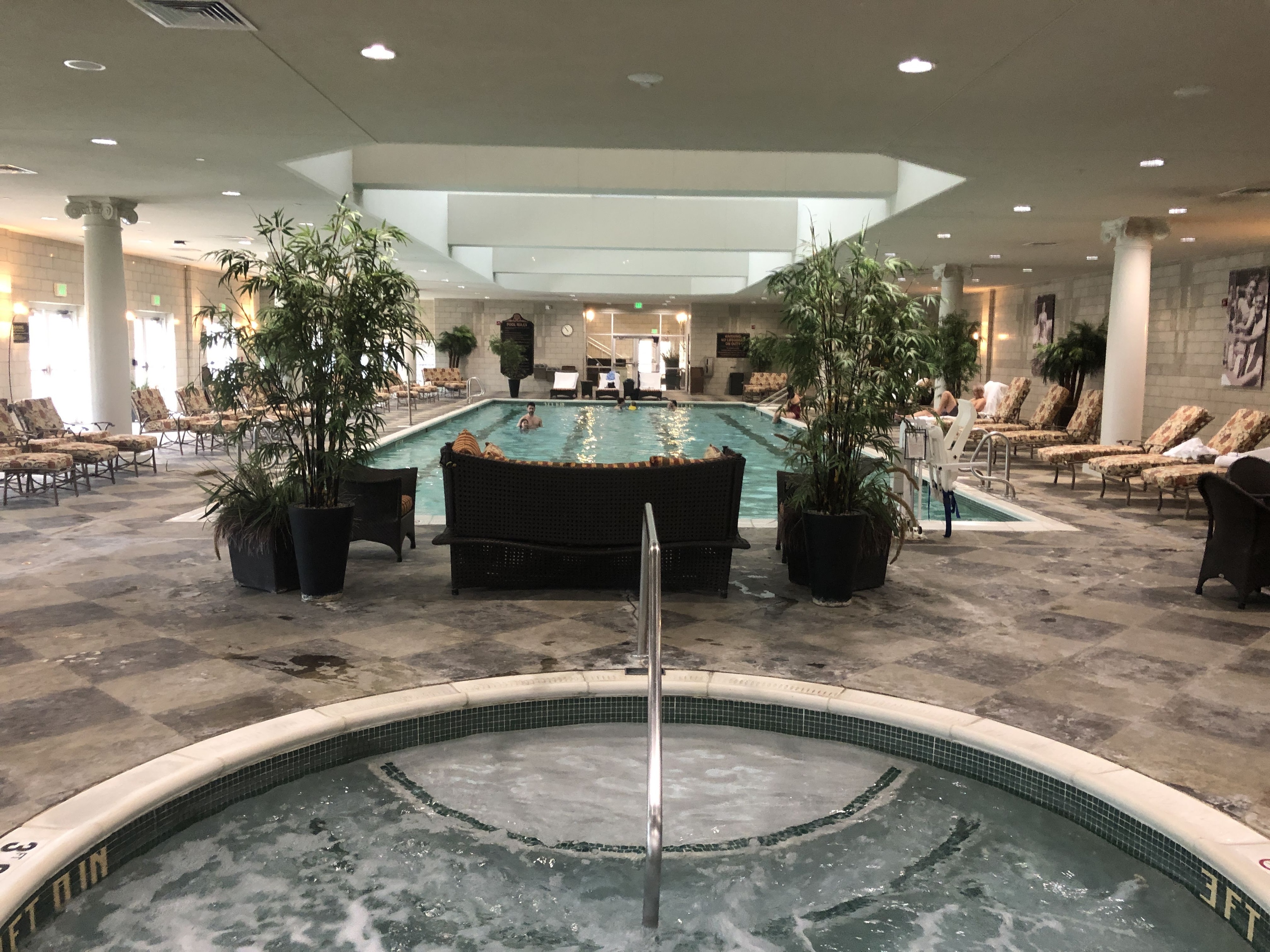 a indoor pool with people swimming in it