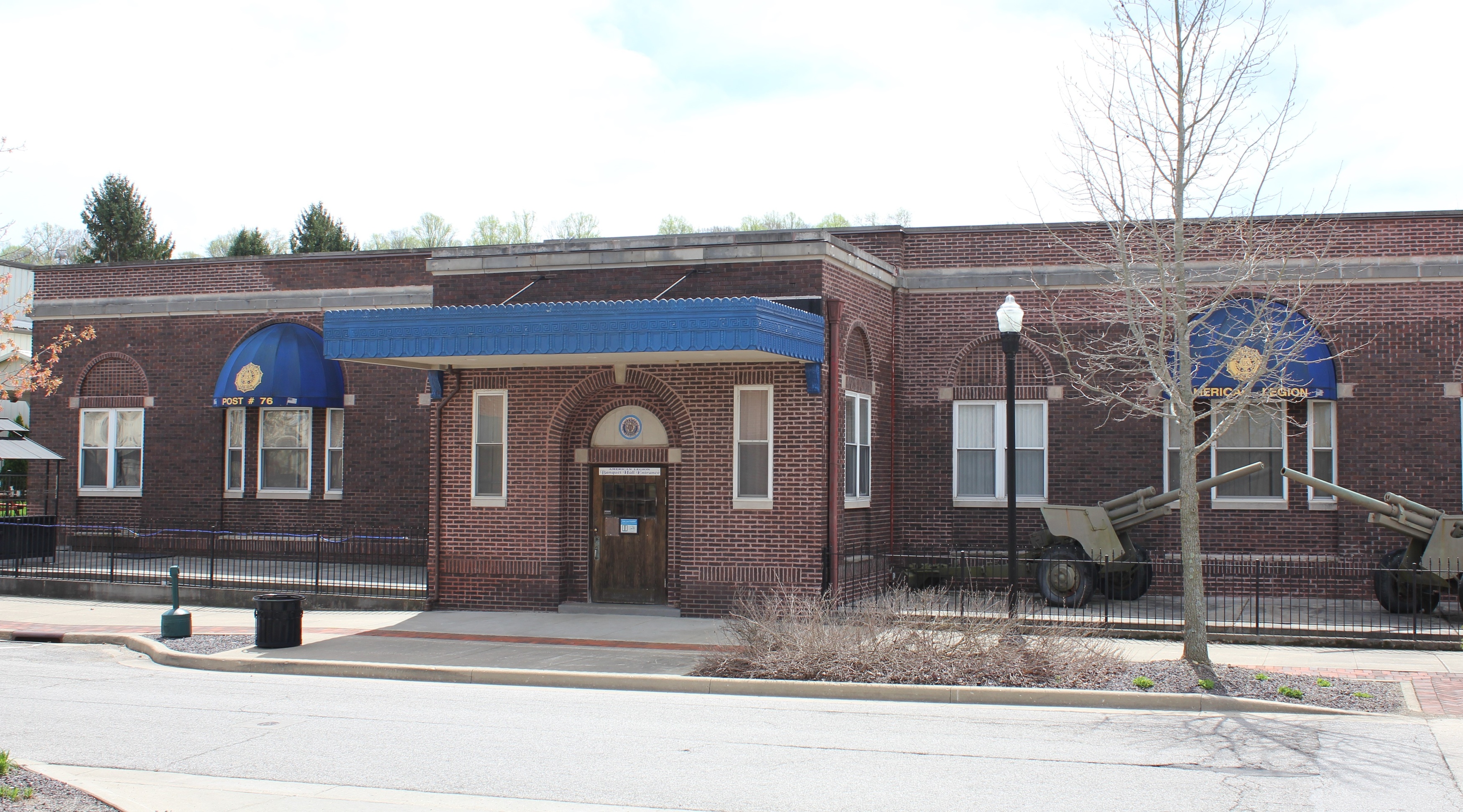 a brick building with a blue awning