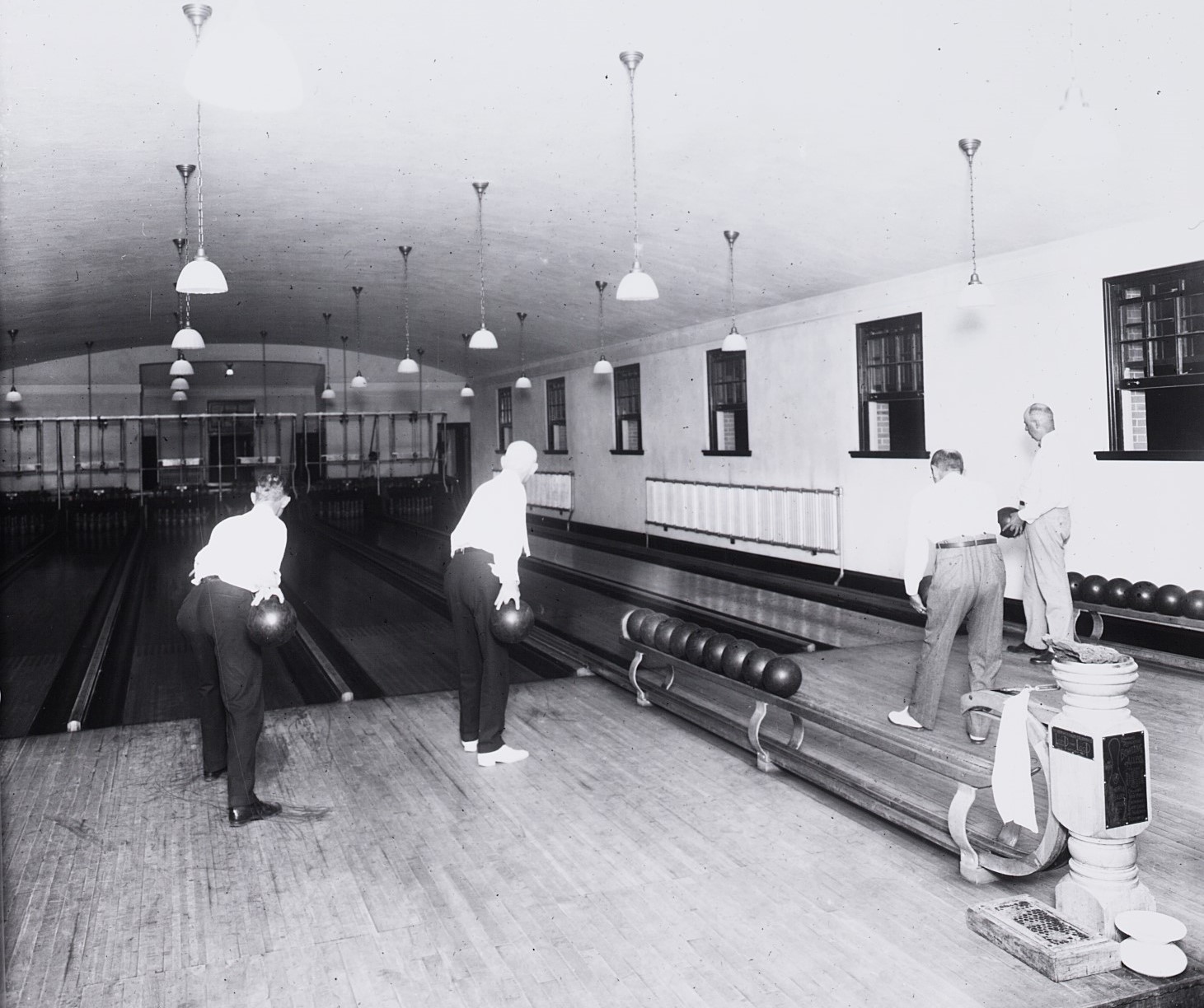 men standing in a bowling alley