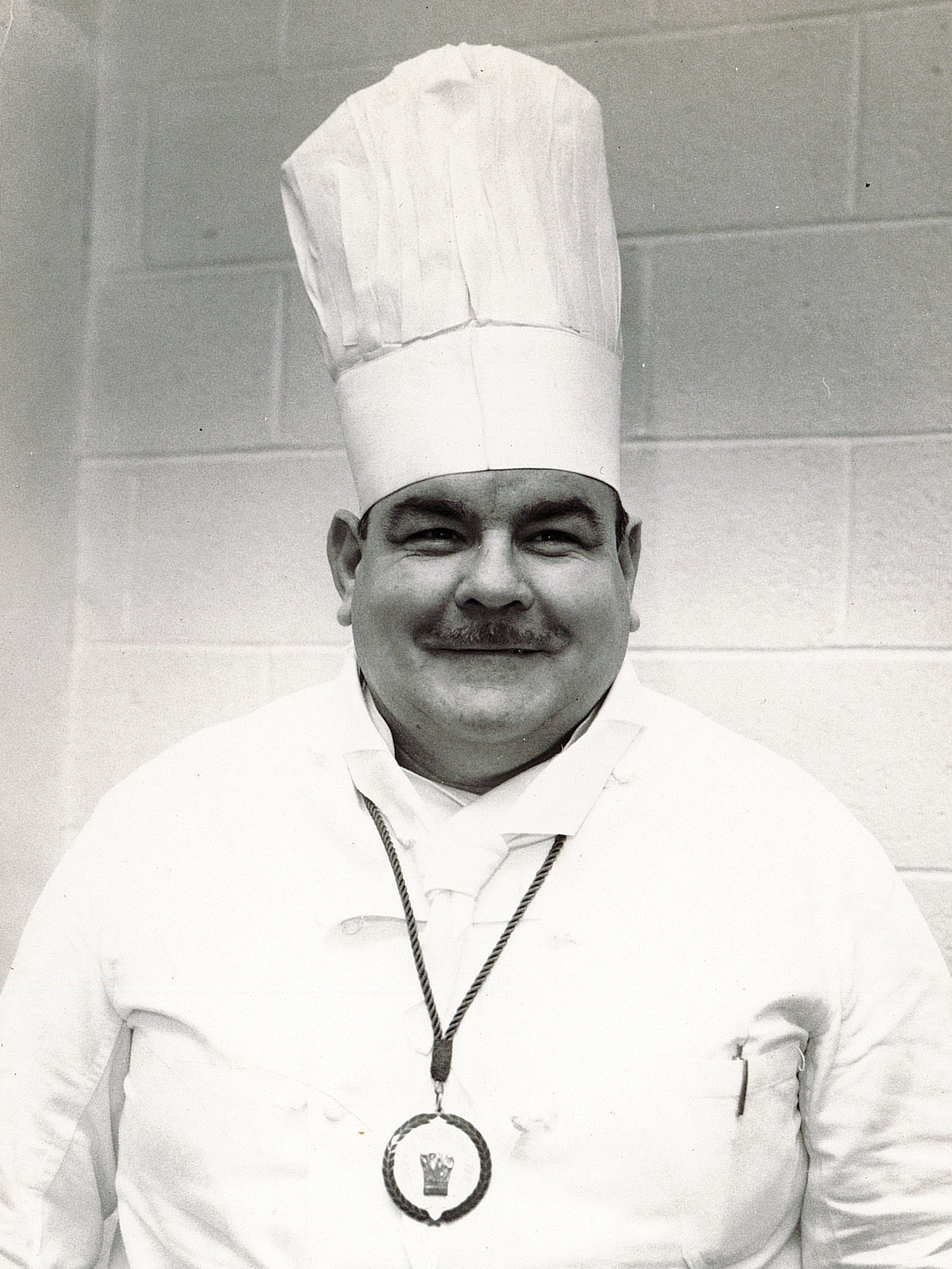 a man wearing a chefs hat