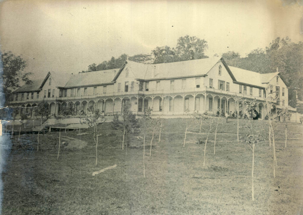 a large house with trees in the background