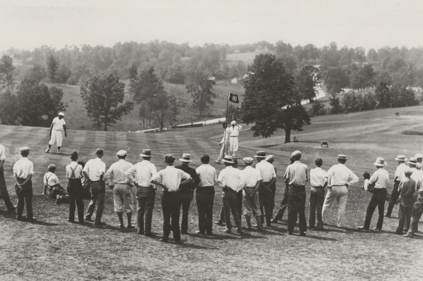 a group of people standing on a golf course