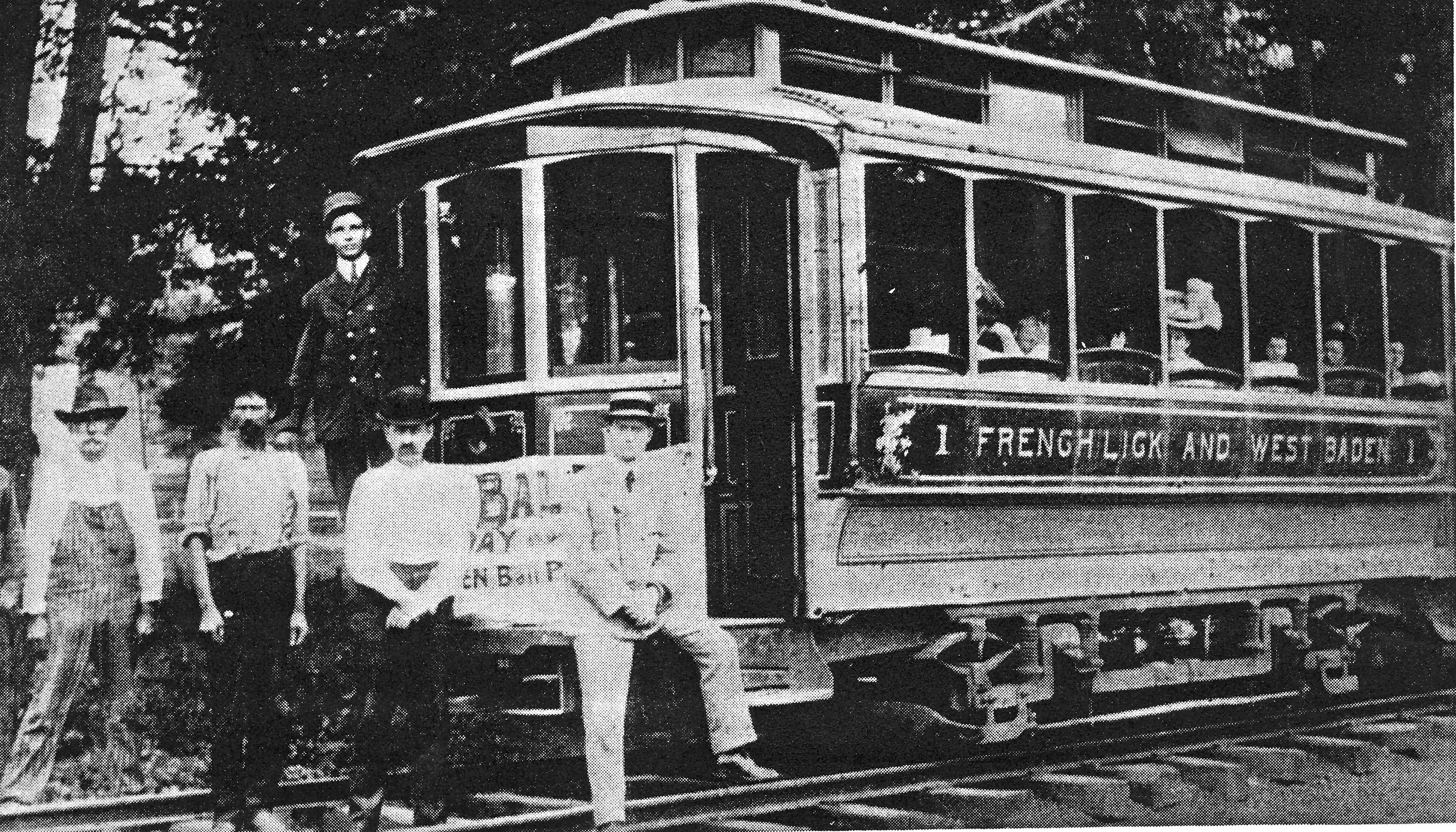 a group of men sitting on a trolley