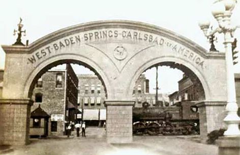 a stone arch with a train in the background