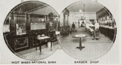 a black and white photo of a room with a few tables and a man walking