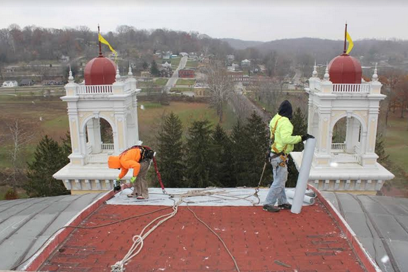 a group of men working on a roof