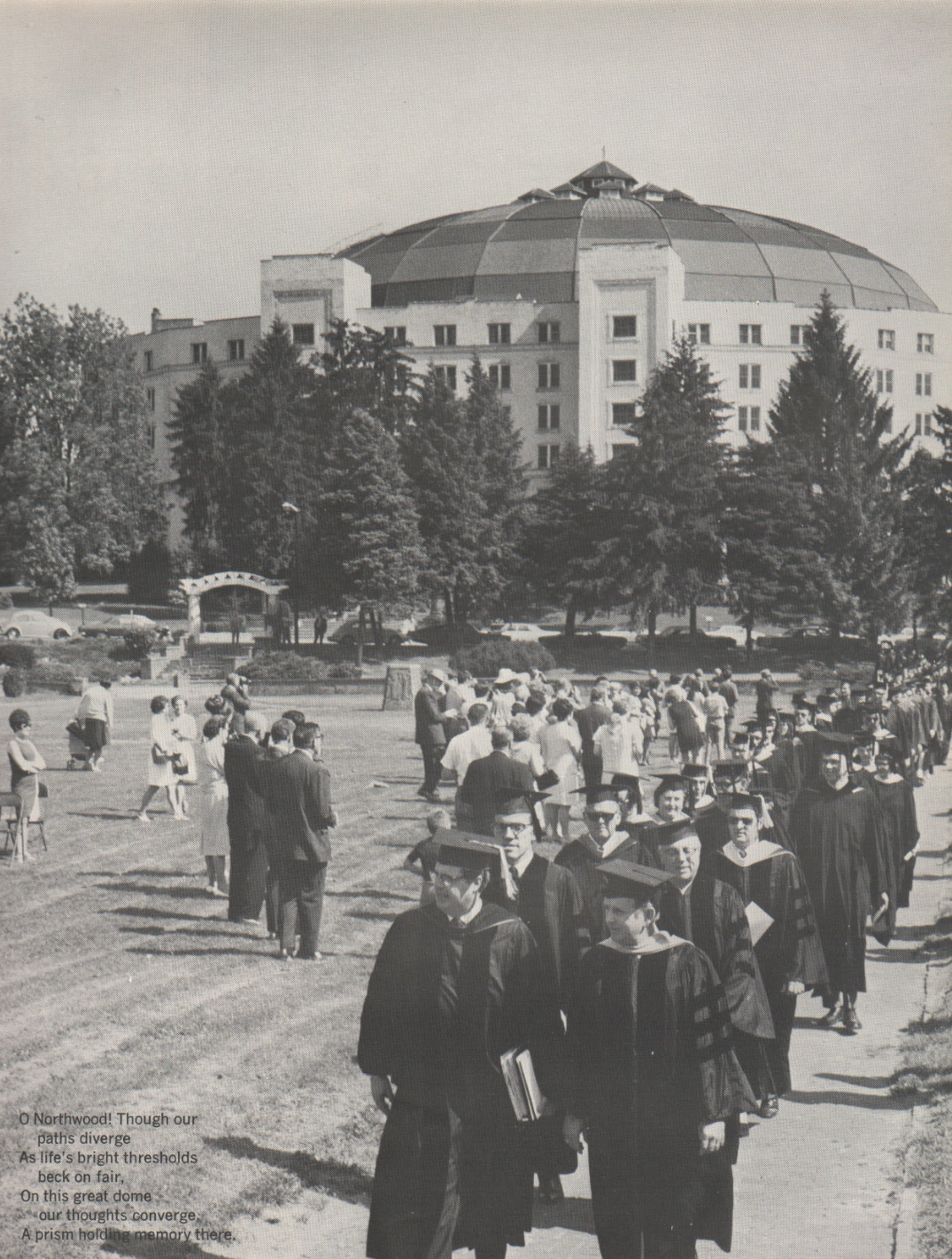 a group of people in graduation gowns outside a building