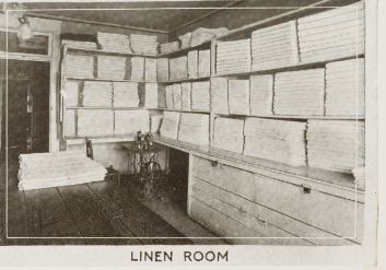 a room with linens on shelves